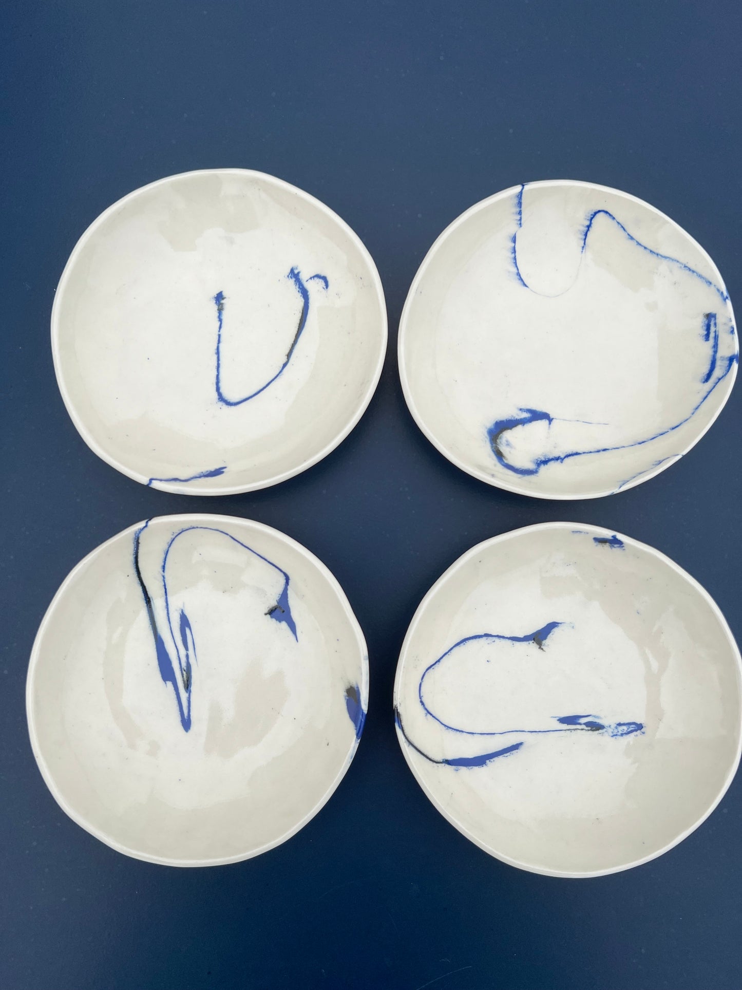 set of four marble blue and black dishes