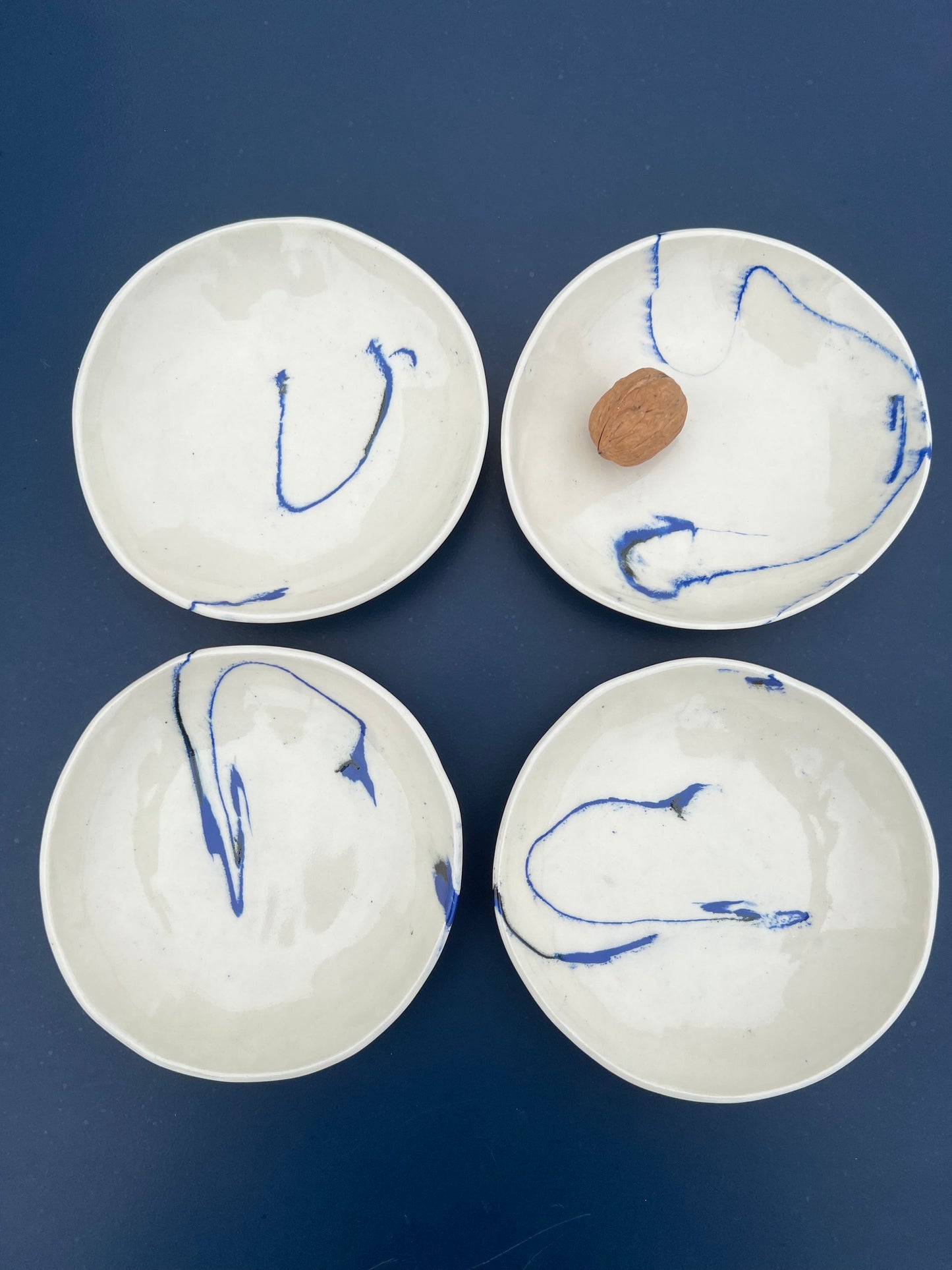 set of four marble blue and black dishes